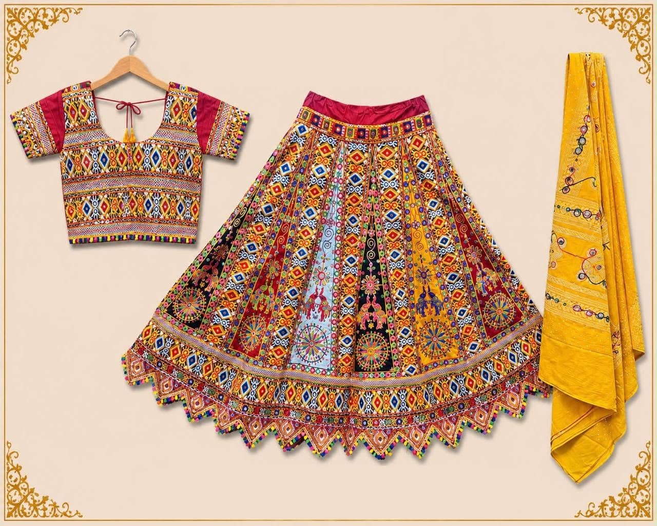 Multicolour panelled skirt in dense kutchi embroidery with a zigzag pompom hem, matching blouse and a mustard mirror-work dupatta