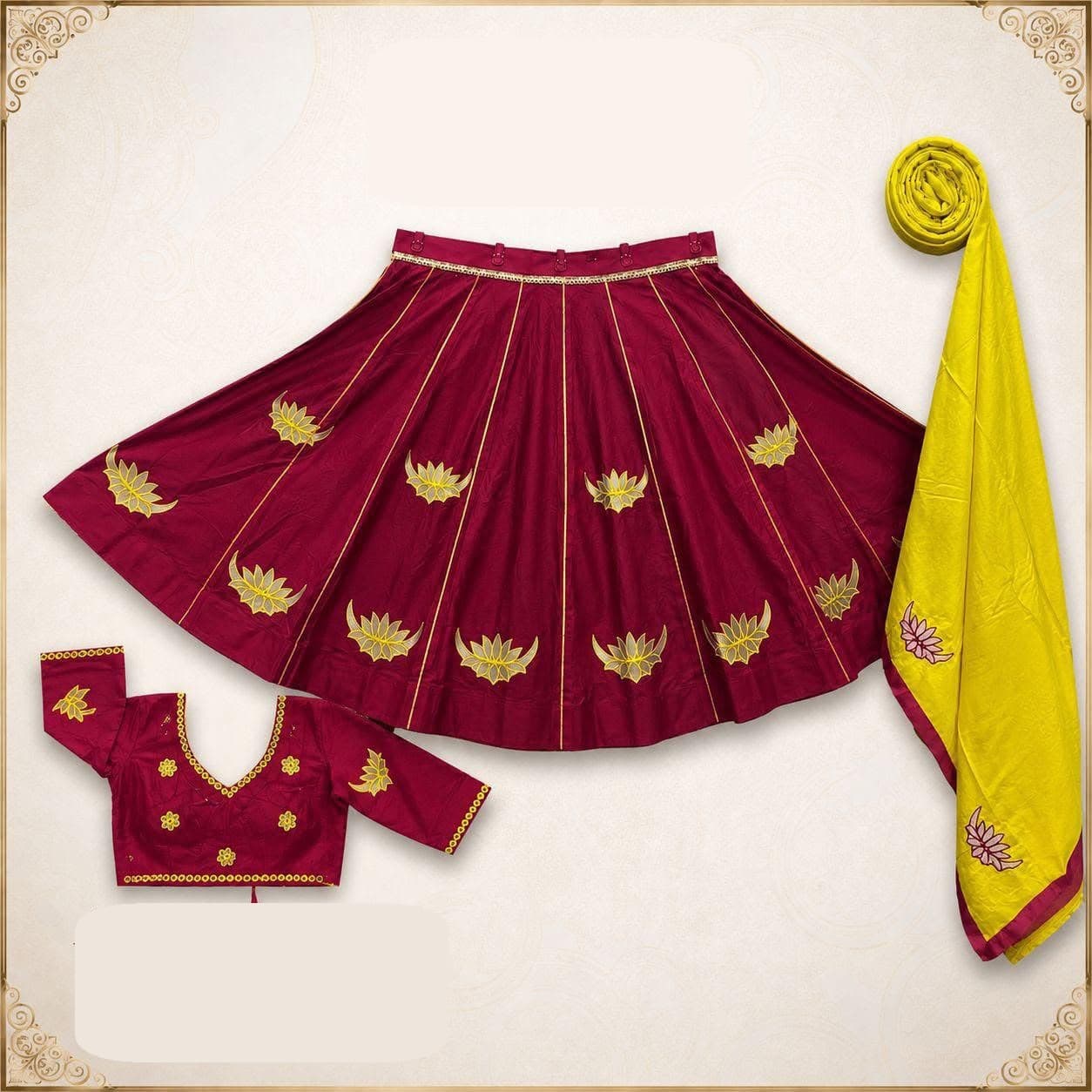 Maroon panelled skirt with gold lotus cut-work appliqué, matching blouse and a yellow dupatta