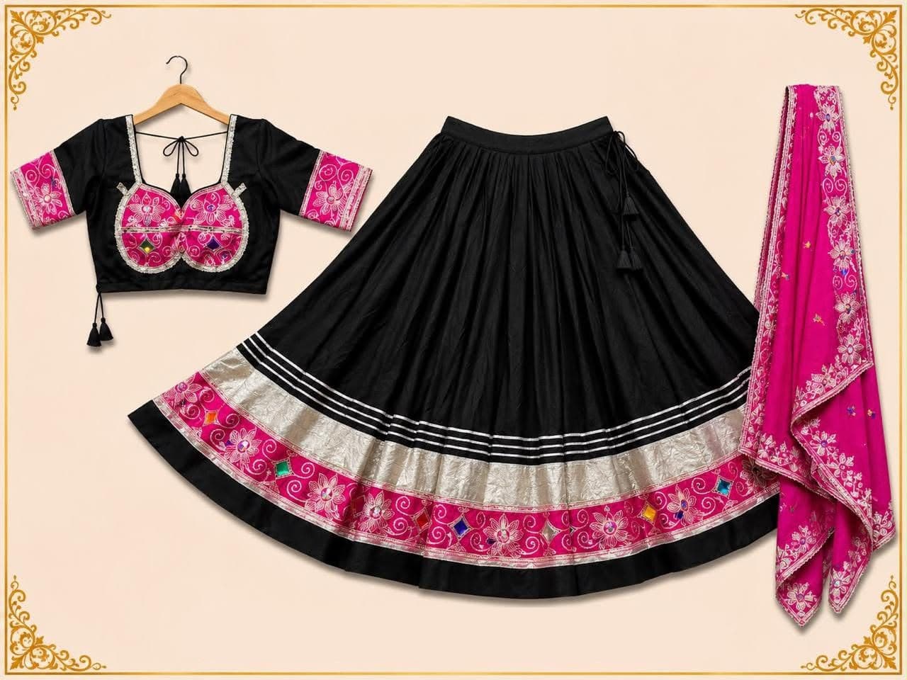 Black flared skirt with silver and pink embroidered borders, black blouse with pink embroidered panels and a pink dupatta